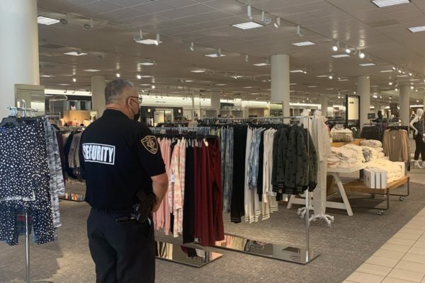 OPS Security GUard inside a store for clothing in a mall in Los Angeles